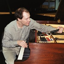 Christopher Haberbosch puts finishing touches on grand piano.
